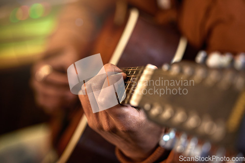 Image of Studio, musician and guitar in a closeup with hands for performance with talent for production. Acoustic, instrument and male artist with learning, skills with creativity for track with sound.