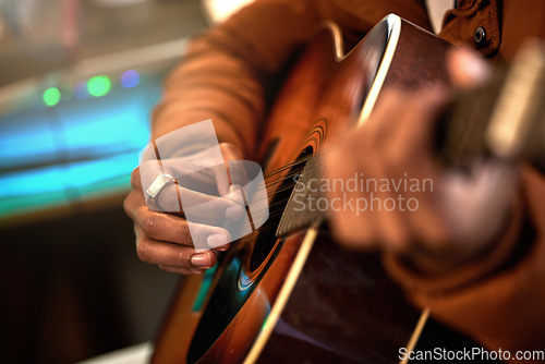 Image of Guitar, hands and man in a studio with a closeup for production with musician and creativity. Artist, playing and acoustic instrument with hand for performance with audio and skills at the house.