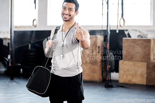 Image of Portrait, thumbs up and happy man in gym with bag for sports goals, fitness target and training. Face, like hand gesture and Asian athlete with emoji for support, success and thank you for exercise.