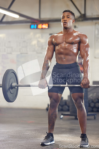 Image of Fitness, muscle and a black man bodybuilder with a barbell in the gym during a physical workout routine. Exercise, strong and sweat with a shirtless male athlete lifting weights in a sports center