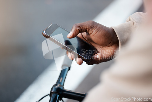 Image of Man, hands and phone with screen on bicycle for social media, communication or networking on mockup in city. Closeup of male person typing or texting on bike with mobile smartphone in an urban town