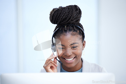 Image of Call center, computer and black woman smile for telemarketing, customer service or support. Contact us, crm and African female sales agent, consultant or employee consulting in business office online