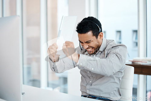 Image of Angry, frustrated and consultant breaking keyboard and fail or computer glitch in a call center or agency office. Stress, insurance and man employee with a problem and risk to the company or business