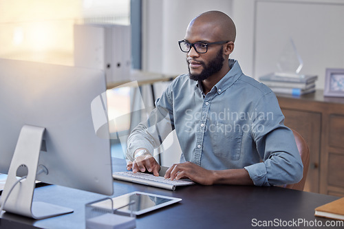 Image of Programmer, computer and black man typing for software, coding or email in office. IT, desktop and African professional working on cyber security, business code or internet research for programming.