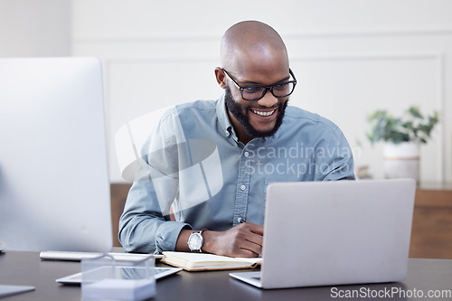 Image of Laptop, writer and black man with notebook, smile and working on business project in office. Computer, happy and African professional taking notes, copywriting or research, planning and reading email