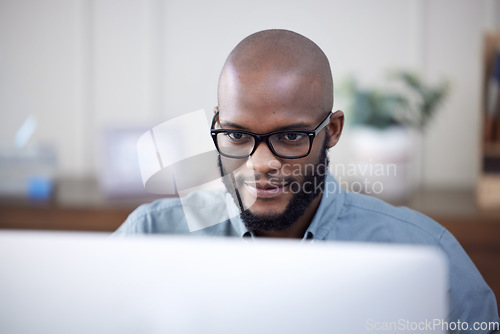 Image of IT, computer and black man work on business software, coding or email in office. Desktop, programmer and African professional working on cyber security, software or internet research for programming.