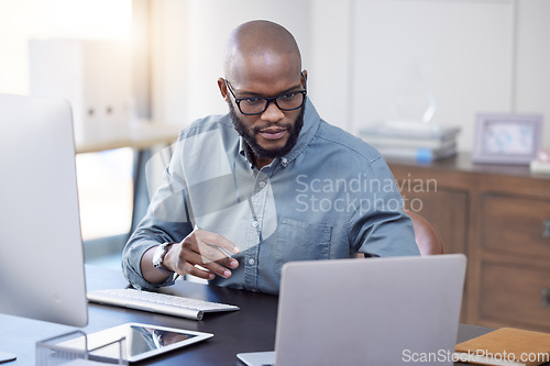 Image of Programmer, laptop and black man reading software, coding or email in office. IT, computer and African professional working on cyber security, business or focus on research for information technology