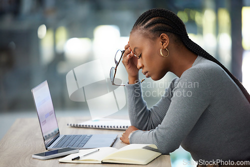 Image of Mental health, businesswoman with headache and laptop at her desk in modern workplace office. Anxiety or burnout, problem or mistake and African woman stress or tired at her workspace with notebook