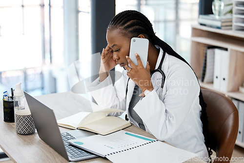 Image of Hospital, doctor and black woman with stress on a phone call for conversation, talking and discussion. Healthcare, burnout and female worker on smartphone for medical service, consulting and help