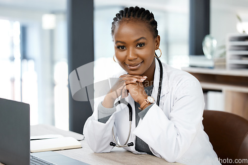 Image of Hospital office, doctor and portrait of black woman with laptop for medical research, wellness app and internet. Healthcare, clinic and happy female worker for consulting, medicare service and help