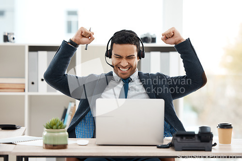 Image of Business man, telemarketing and success with celebration and work promotion email. Male worker, win and good news on a laptop in a office with motivation and typing at call center job with tech