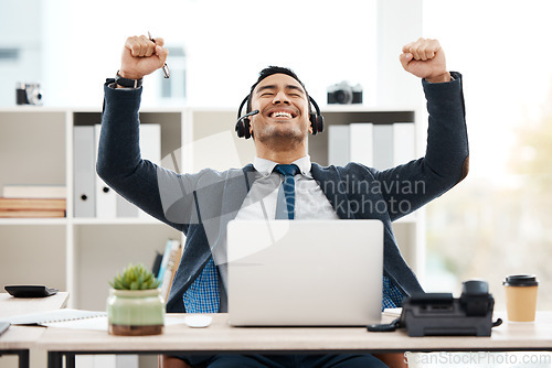 Image of Business man, success and call center with celebration and work promotion email. Male worker, win and good news on a laptop in a office with motivation and typing at telemarketing job with smile