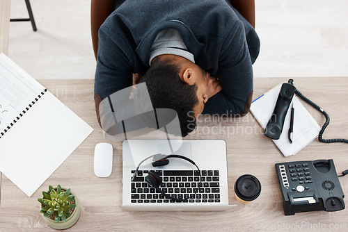 Image of Sleeping, business man and call center work from above with fatigue in office. Telemarketing, contact us and phone consultation worker feeling tired and overworked at company with deadline and sleep