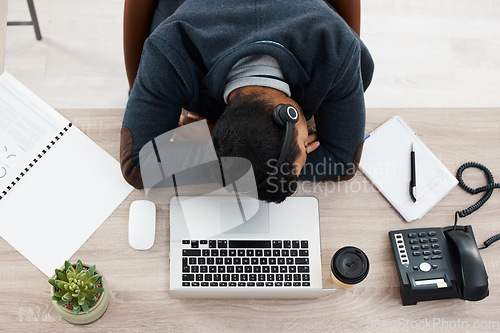 Image of Sleeping, business man and call center desk from above with fatigue in office. Telemarketing, contact us and phone consultation worker feeling tired and overworked at company with deadline and sleep