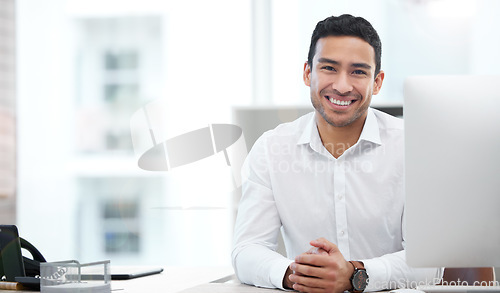 Image of Happy, portrait of a businessman and computer working at his desk at his workplace office. Happiness or cheerful, health wellness and male person happy at his workstation by desktop at work.