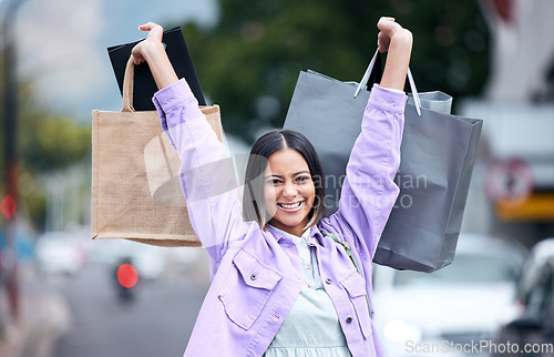 Image of Shopping bags, portrait and woman in the city for fashion, retail and brands of clothes on sale, discount or promotion. Smile, girl and shopper with luxury, boutique or designer products from store