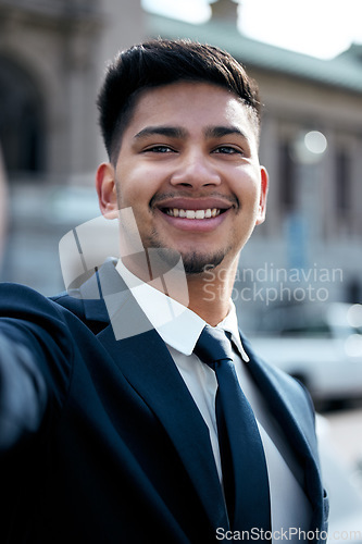 Image of Portrait, lawyer and selfie of business man in city, smile and taking photo for social media in urban street. Face, smile and profile picture of professional, entrepreneur or male attorney from India