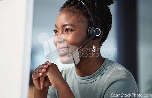 Image of Call center, customer service and support with a black woman consultant working in her office at night. Contact us, crm and consulting with a happy young female employee at work in telemarketing