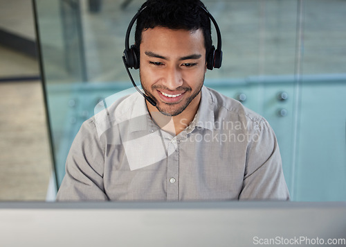 Image of Call center, customer support and male consultant in the office doing research on crm communication. Headset, technology and telemarketing agent working on an online client consultation in workplace.