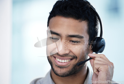 Image of Call center, listening and business man smile for telemarketing, customer service and support in office mockup. Crm, contact us and Asian male sales agent, consultant and professional with microphone