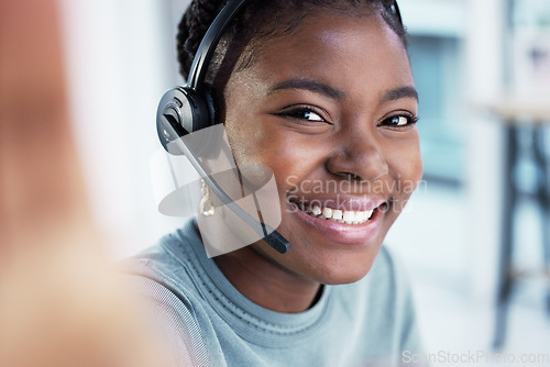 Image of Selfie, face and black woman in call center, smile and telemarketing for customer service or support in office. Portrait, contact us and African female sales agent taking professional profile picture