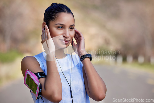 Image of Music, outdoor fitness and woman listening to wellness podcast, exercise audio and workout or training. Radio, listen and young runner, sports person or athlete, exercise motivation and street
