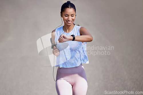 Image of Fitness, watch and woman running in the road for race, competition or marathon training. Sports, workout and young female athlete checking the time for her outdoor cardio exercise in the street.