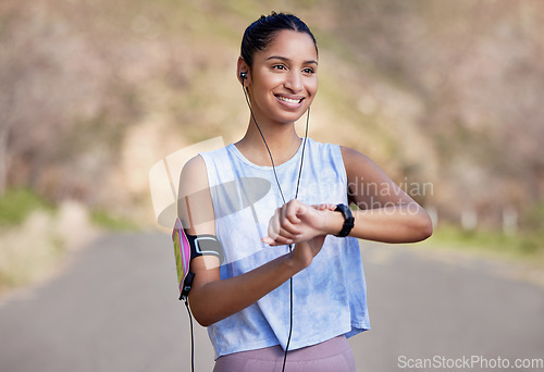 Image of Fitness, smartwatch and woman on a break from running in the road for race or marathon training. Sports, workout and female athlete checking the time for her outdoor cardio exercise in the street.