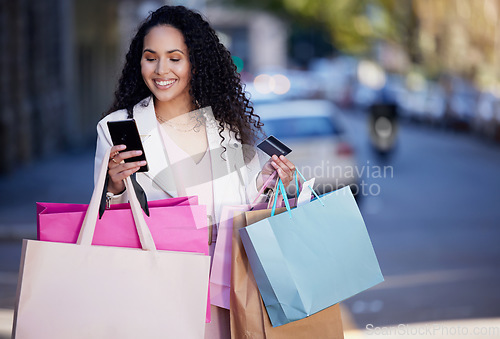 Image of Shopping bag, phone and credit card with woman in city for digital payment, fintech and ecommerce app. Fashion, retail and finance with female customer in street for luxury, sale and online banking
