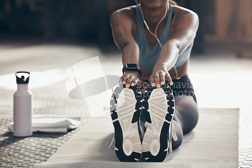 Image of Woman is stretching in gym, fitness and feet with workout start, sneakers and sport preparation. Healthy, active with Indian female warm up and ready for exercise with flexibility on mat for training