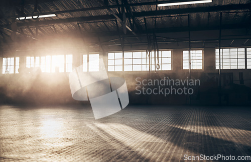 Image of Empty, gym and interior space or dark room with window and light flare for exercise, training and fitness workout. No people, sports club and floor layout of exercising venue, facility and gymnasium