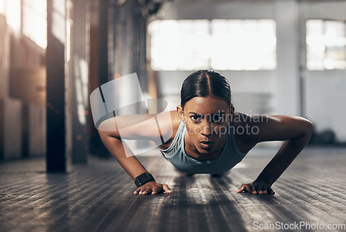 Image of Push ups, workout and portrait of woman in gym for challenge, exercise and performance. Health, strong and sports with female bodybuilder training in fitness center for energy, wellness and focus