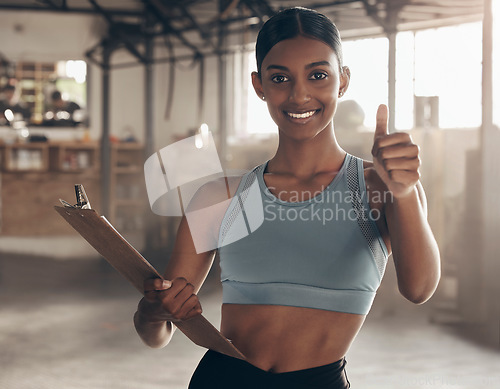 Image of Thumbs up, clipboard and personal trainer with portrait of woman in gym for checklist, motivation and achievement. Workout, training and exercise with female bodybuilder for fitness, support and goal