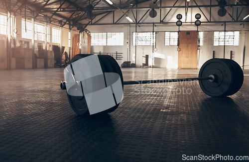 Image of Weightlifting, fitness and barbell on floor of gym for training, workout and bodybuilding. Muscle, strong and weights with sports equipment in empty room for exercise, challenge and performance