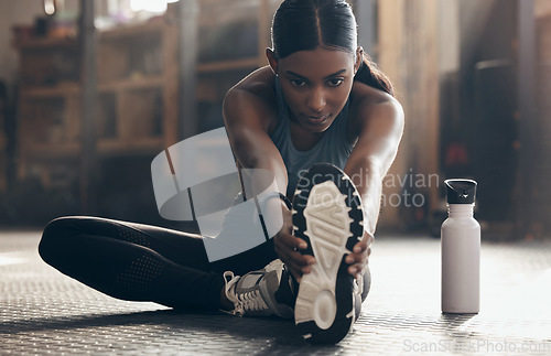 Image of Woman is stretching legs in gym, fitness and start workout with focus, sneakers and sport preparation. Health, active with serious Indian female warm up and ready for exercise with determination