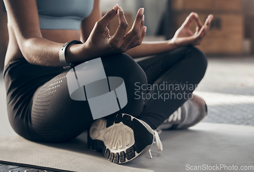 Image of Hands, yoga lotus and gym with woman on floor for self care, training and fitness with mindfulness. Girl, zen meditation and peace with mindset, workout and relax with breathing exercise for health