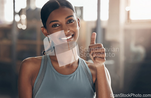 Image of Woman in gym, thumbs up in portrait and fitness with like emoji, smile and health goals with sport and mockup space. Hand gesture, yes and motivation with Indian female athlete at exercise studio