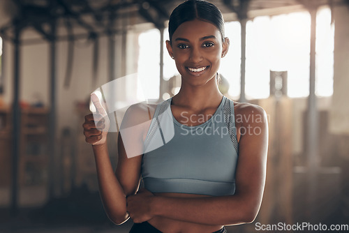 Image of Woman in gym, thumbs up with smile in portrait, like fitness with emoji and health goals with sport and mockup space. Hand gesture, yes and motivation with Indian female athlete at exercise studio