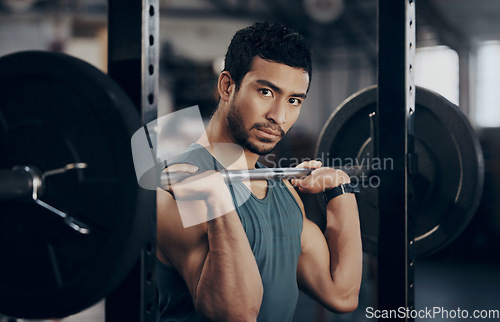 Image of Man, portrait and push press barbell for workout at the gym for strong muscles in a close up. Male athlete, exercise and weight lift for fitness at a club with equipment for healthy body with cardio.