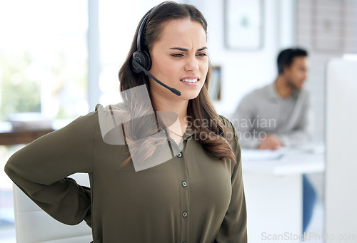 Image of Call center, back pain and woman, agent or consultant on computer for burnout, health problem and stress. Telecom, customer support and agency worker or young person, spine or muscle injury at desk