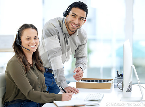 Image of Call center, man coaching woman and smile in portrait, office and writing notes for learning at telemarketing job. Crm, teaching and notebook for customer service, consulting and tech support with pc