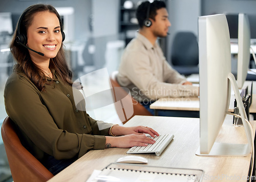 Image of Woman typing at computer, call center and contact us with communication and CRM with tech support. Customer service, help desk and telemarketing, female consultant and smile in portrait with telecom