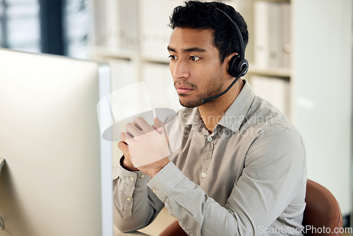 Image of Man at computer, call center and headset with contact us, communication and CRM with tech support. Customer service, help desk and telemarketing with serious male consultant and professional service