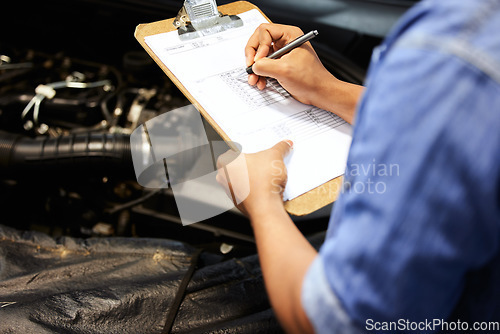 Image of Hands, car mechanic and writing on checklist for service, maintenance and document repair list. Hand, man and engineer with vehicle inspection survey, report and checking engine motor in garage