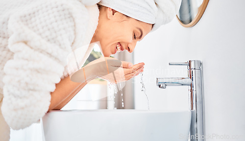 Image of Water splash, skincare and happy woman washing her face in a bathroom for beauty, hygiene and wellness. Facial, cleaning and female with drops for dermatology and cleansing treatment in her home