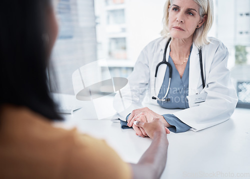 Image of Consulting, support and holding hands of doctor and patient for medical, empathy and advice. Medicine, healthcare and help with women in hospital exam room for depression, compassion and hope