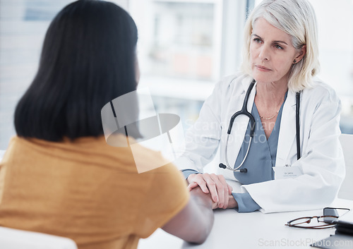 Image of Empathy, compassion and holding hands of doctor and patient for medical, trust and advice. Medicine, healthcare and help with women in hospital consulting room for depression, support and hope