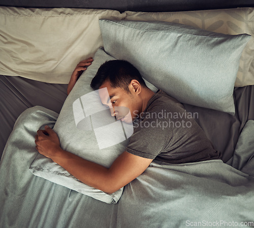 Image of Sad, tired and depression with man in bedroom for burnout, fatigue and mental health. Anxiety, lonely and depressed with male person feeling grief in bed at home for frustrated, problem and morning