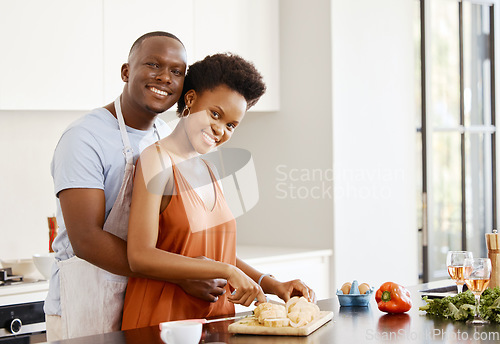 Image of Portrait, hug and black couple in a kitchen for cooking, meal and bonding in their home together. Food, face and happy woman and man with love preparing dinner with bread, nutrition and vegetable