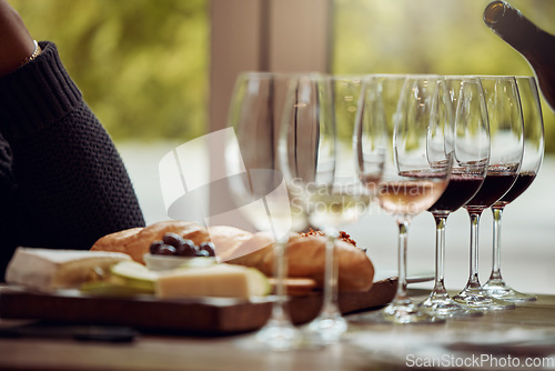 Image of Wine tasting, cheese platter and winery restaurant with alcohol and glass for customer. Waiter, drink and sommelier with bottle for wines and food pairing in a fine dining and luxury experience